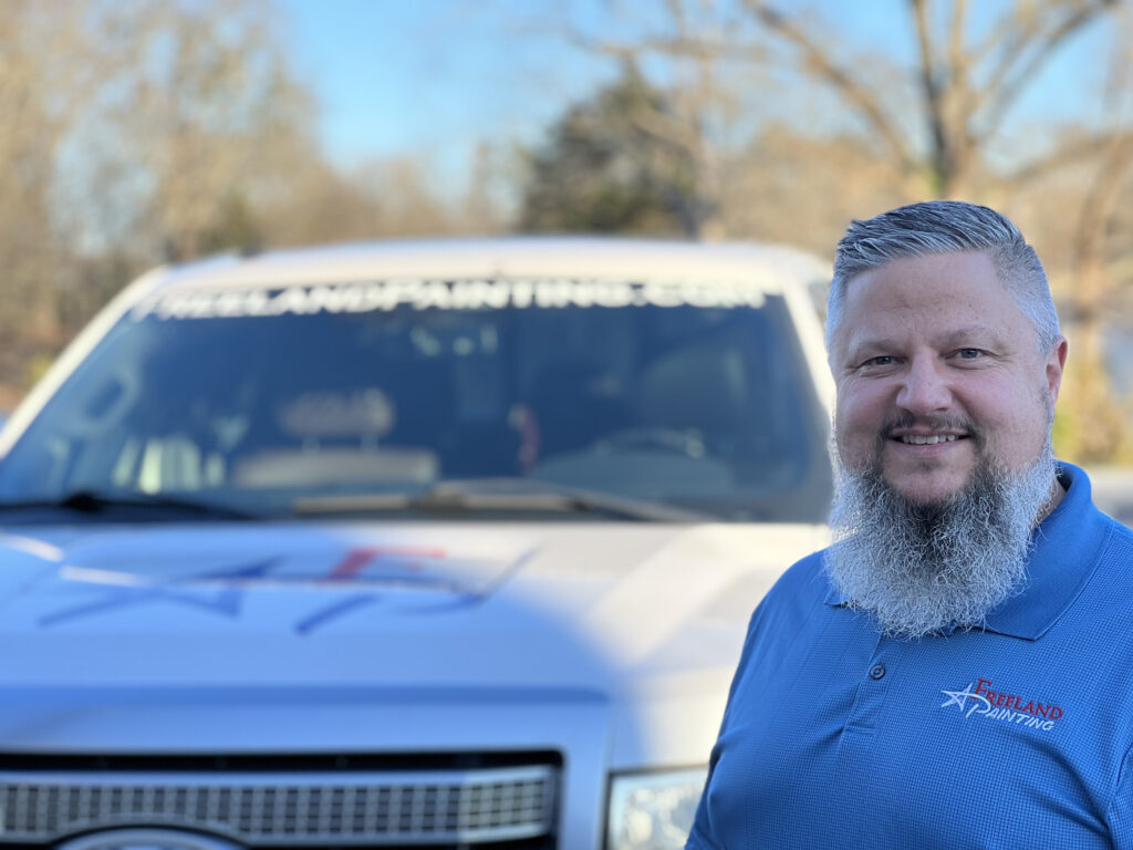 Doug Ireland, Owner of Freeland Painting in front of his truck.
